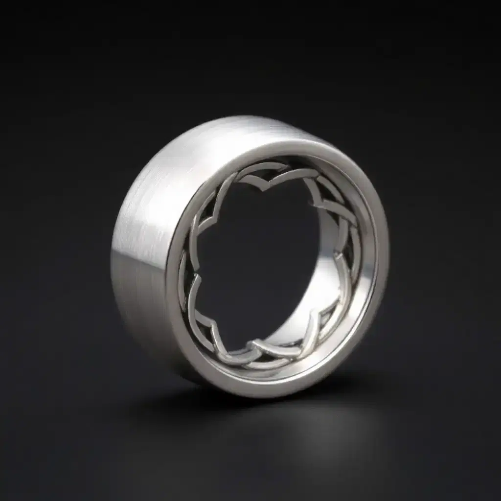 A silver ring, in its middle there is a polished, just brushed, not engraved finish which depicts an intricate Celtic knot pattern engraved around its circumference. All around the ring, the design takes up a third of the space on the ring and is placed in the middle.