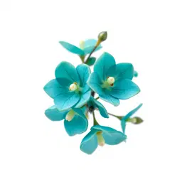 A beautiful, naturally occurring botanical filler motif featuring a small cluster of delicate miniature bell-shaped exotic flowers. Use a sophisticated, dress-worthy colour palette of deep peacock teal, luminous aqua, soft sea-glass turquoise, and subtle touches of rich sapphire blue, with tiny hints of warm champagne-gold at the flower centres. The colours should blend naturally within each flower, with realistic translucent petals, delicate veins, gentle tonal variation, natural folds, and slightly irregular shapes. The flowers grow naturally from slender organic branching stems in a refined antique champagne-silver tone, with realistic botanical structure rather than metallic or jewellery-like construction. A few tiny pearl-like seed details may appear naturally at selected petal tips, extremely subtle and believable. Photorealistic botanical specimen, luxurious Pakistani textile aesthetic, sophisticated couture colour palette, naturally occurring plant structure, realistic petal texture and translucency, subtle imperfections, elegant macro photography, soft studio lighting, crisp isolated edges, clean solid matte-white background. No white flowers, no pastel-white appearance, no artificial symmetry, no fantasy jewellery construction, no glitter, no heavy metallic effect, no geometric arrangement, no frame, no border, no text, no mockup.